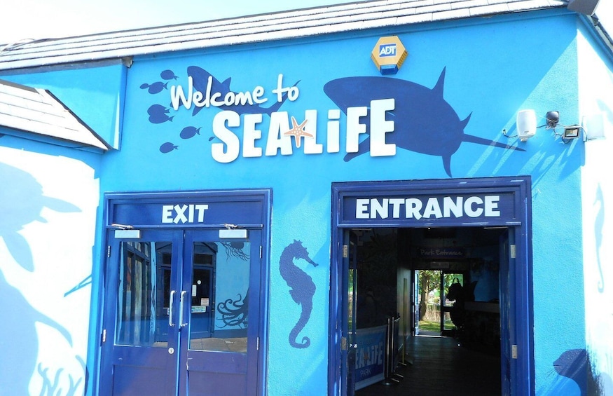 A blue building with 'Welcome to SEAMIFE' and 'EXIT' signs. 4
