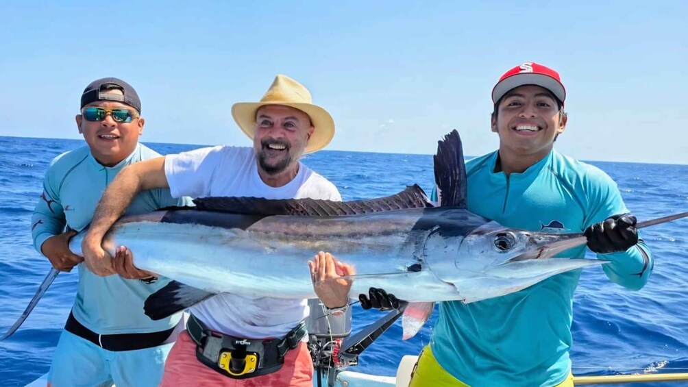 Three people on a boat holding a large fish. 1