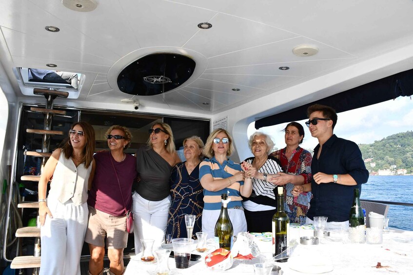 A group of people on a boat with a table set for a meal. 2