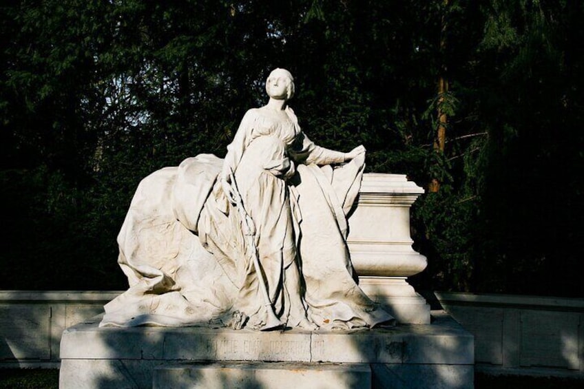 A statue of a woman in a dress with a horse. 2