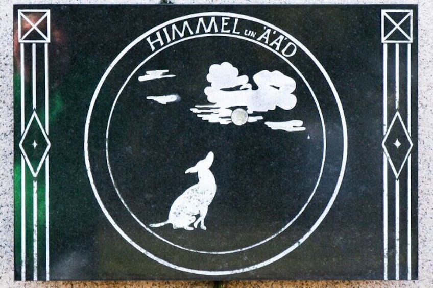 A circular emblem with a kangaroo and clouds, surrounded by geometric patterns. 4
