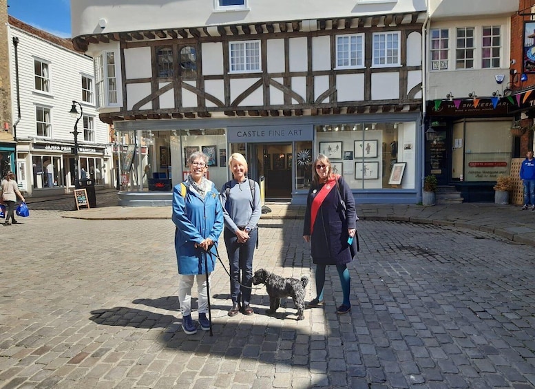 A cobblestone street with a Tudor-style building featuring a 'Castle Fine Art' sign. 4