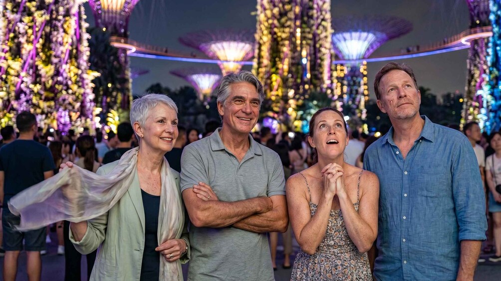 A group of people standing in an outdoor area with decorative lights and structures in the background. 2