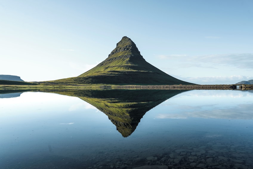 Una montagna riflessa in un lago tranquillo con cielo sereno. 1