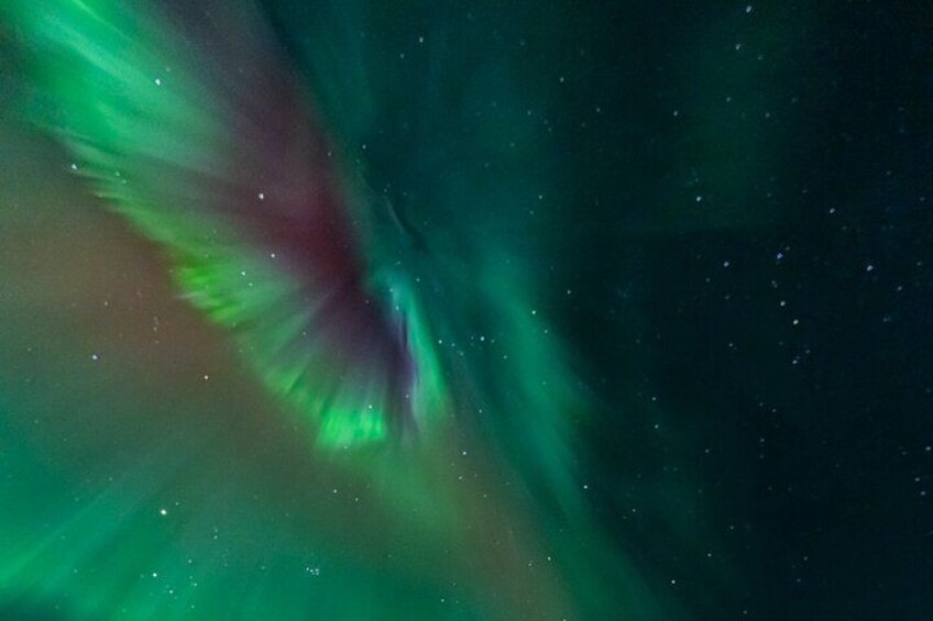 The Northern Lights (Aurora Borealis) with green and red hues. 5