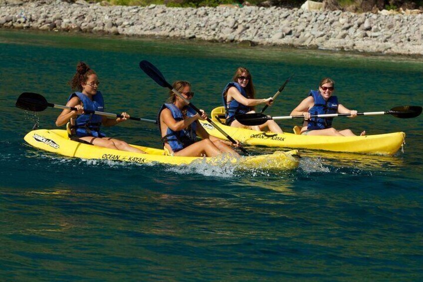 Three people kayaking on a river. 1