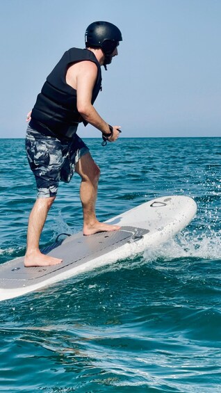 A person surfing on a wave in the ocean. 4