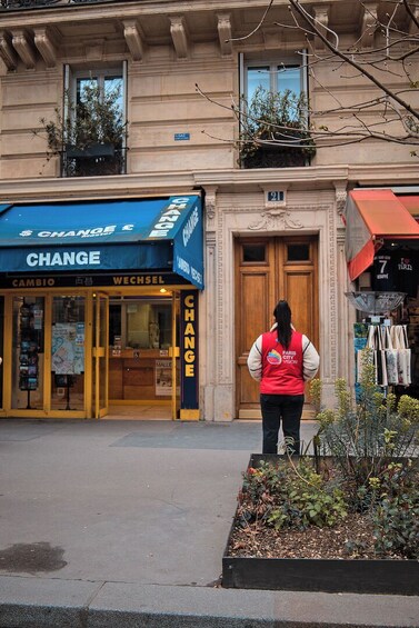 A storefront with a blue awning labeled 'CHANGE' and a person standing in front. 3