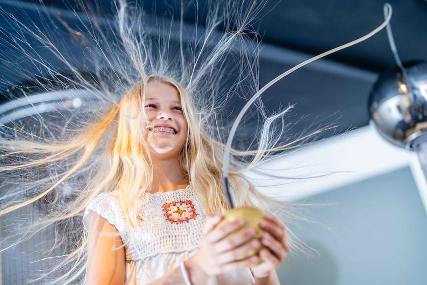 A person with blonde hair holding an apple. 2