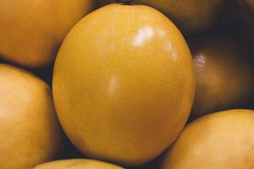 A close-up of several yellow fruits. 2