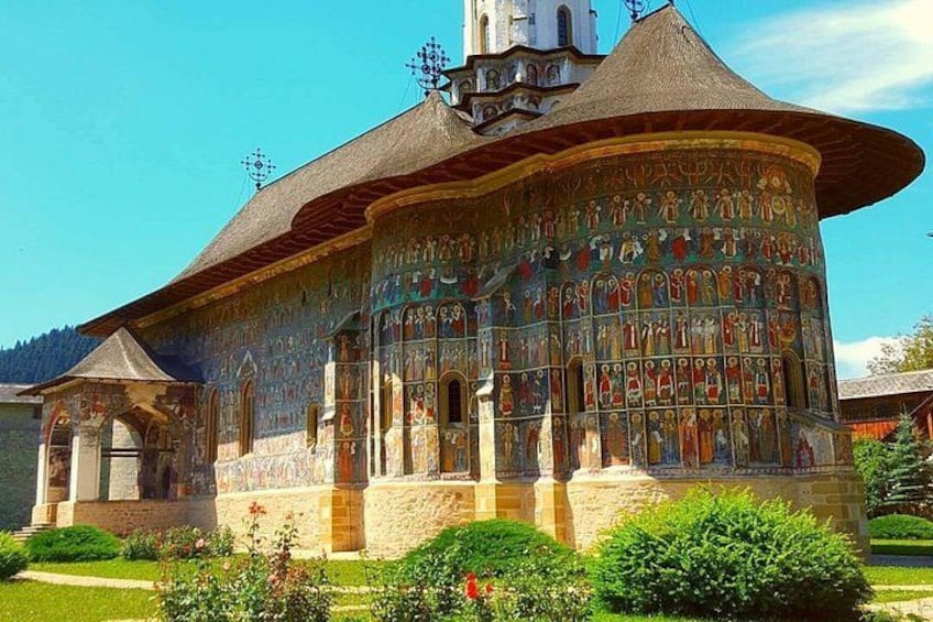 A colorful, intricately decorated church with a dome and bell tower. 1