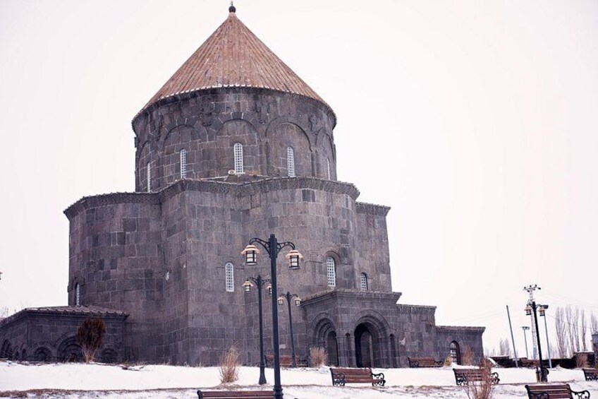 A large stone building with a dome and arched windows. 1