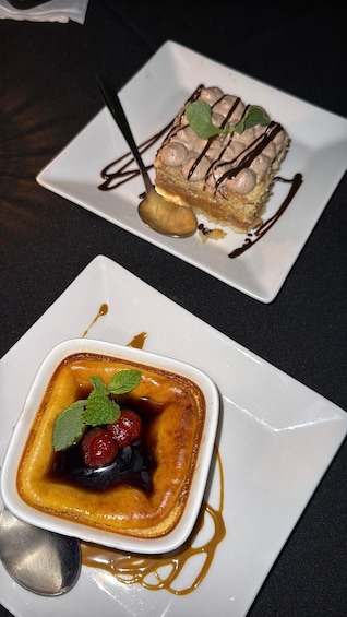 A dessert plate with a chocolate mousse cake and a small bowl of crème brûlée with berries. 1