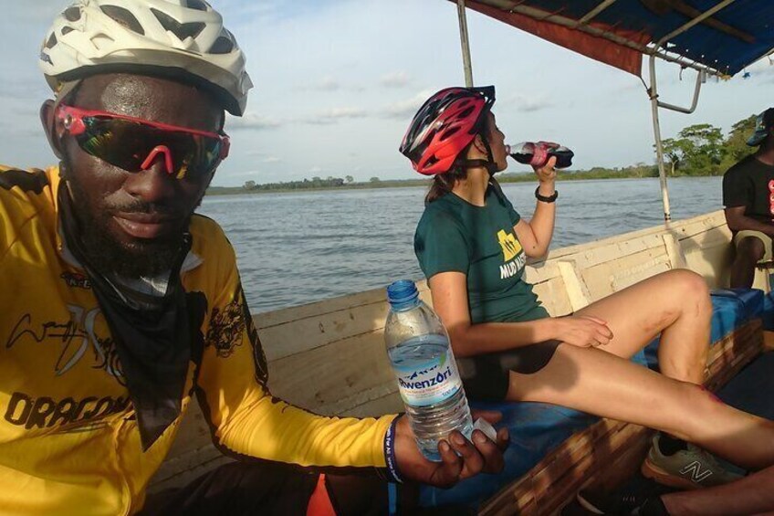 Two people on a boat, one holding a water bottle. 4