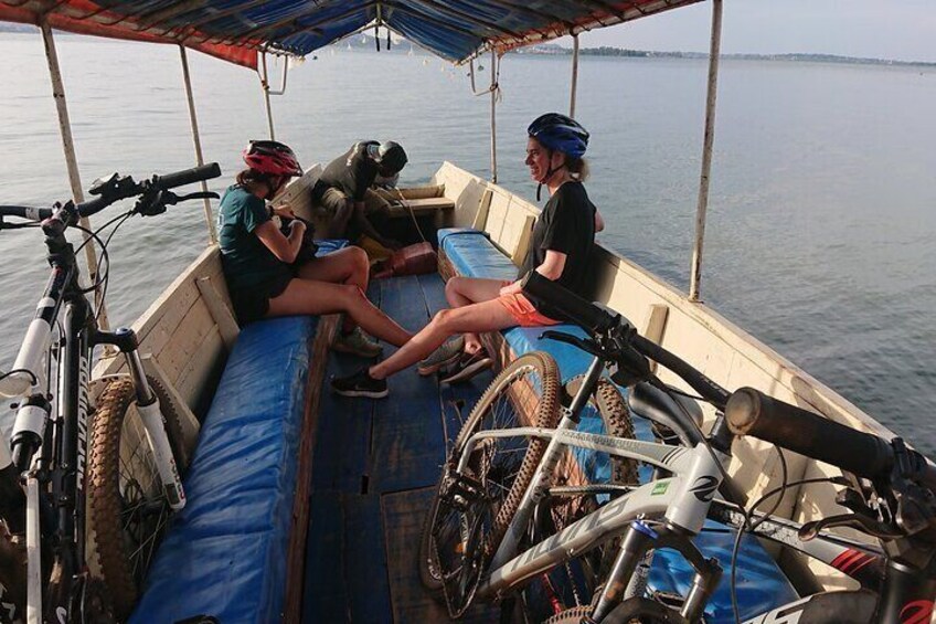 People on a boat with bicycles and a blue tarp. 2