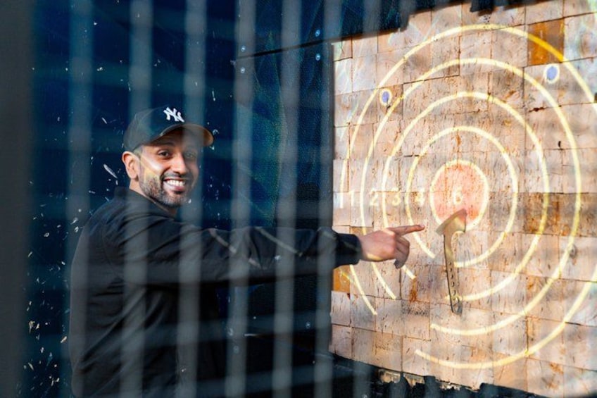 A person aiming at a target with concentric circles. 5