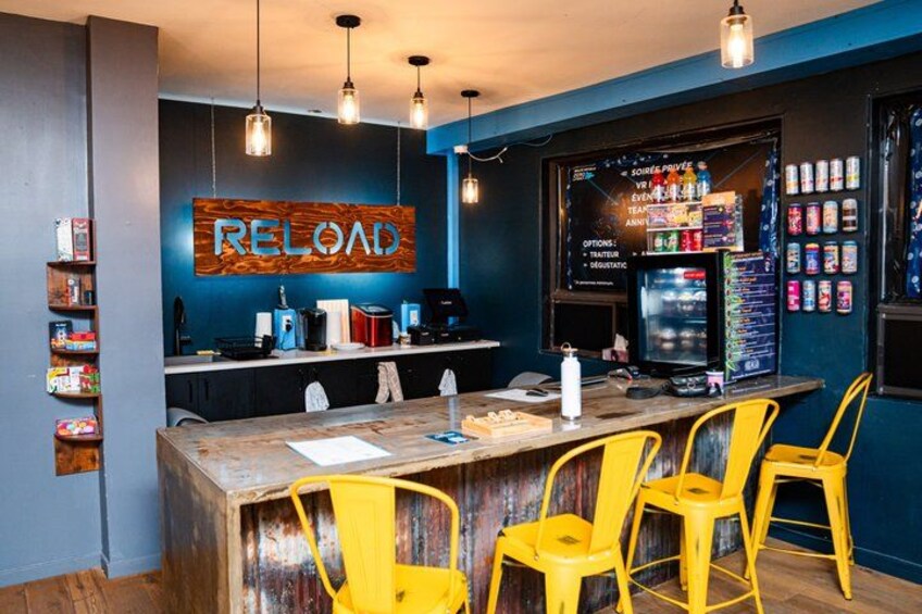 A bar with a wooden counter, yellow chairs, and a 'RELOAD' sign. 3
