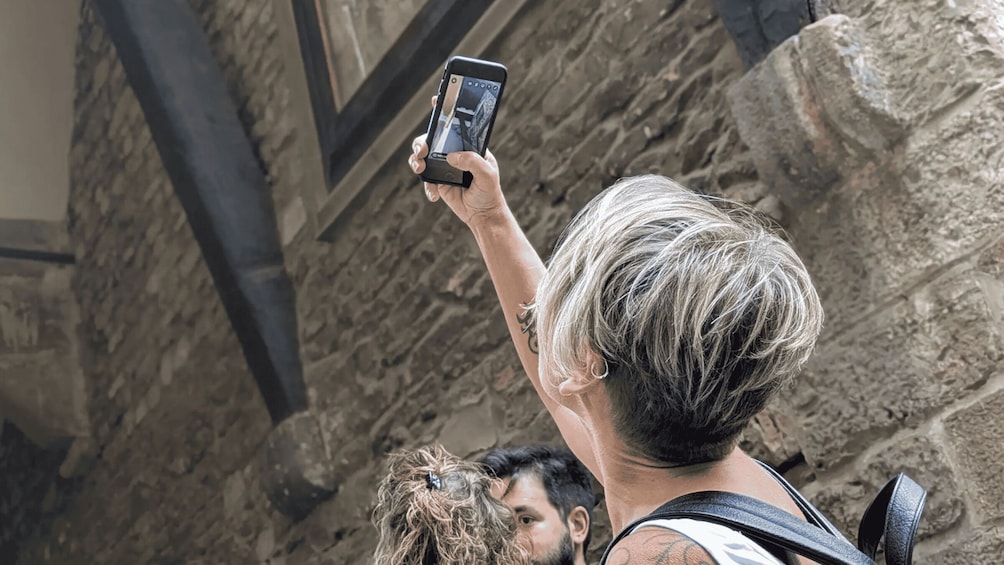 A person taking a photo with a smartphone. 2