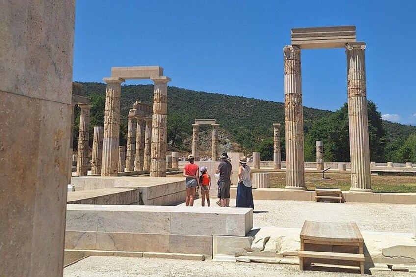 Ancient ruins with columns and a stone structure. 2