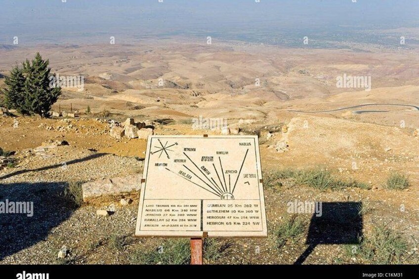 A sign with a map and distance markers. 4