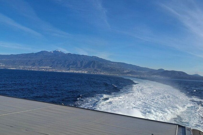 A body of water with a mountain range in the background. 3
