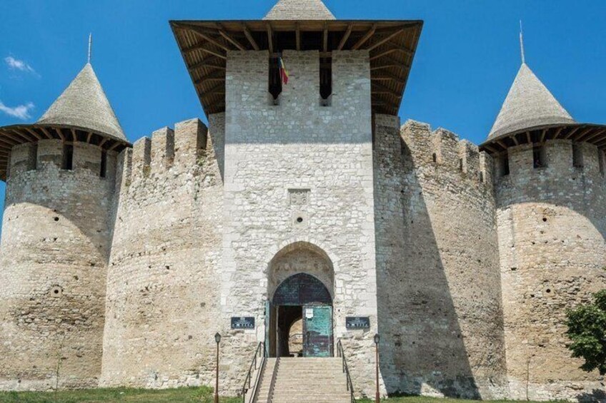 A medieval castle with three towers and a central entrance. 1