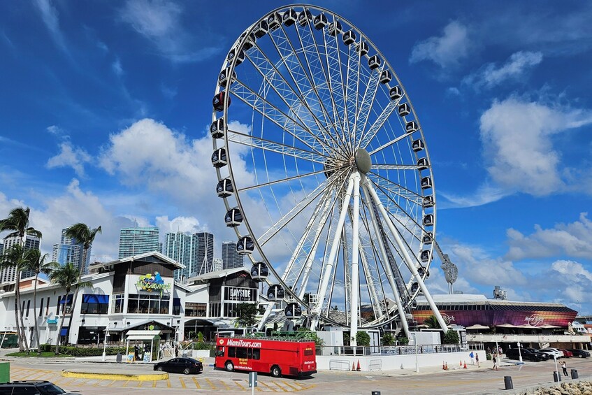 A large Ferris wheel, a red bus, and a Hard Rock Cafe. 2