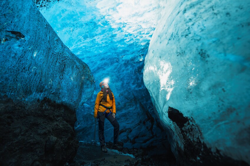 A person in a cave with ice walls. 1