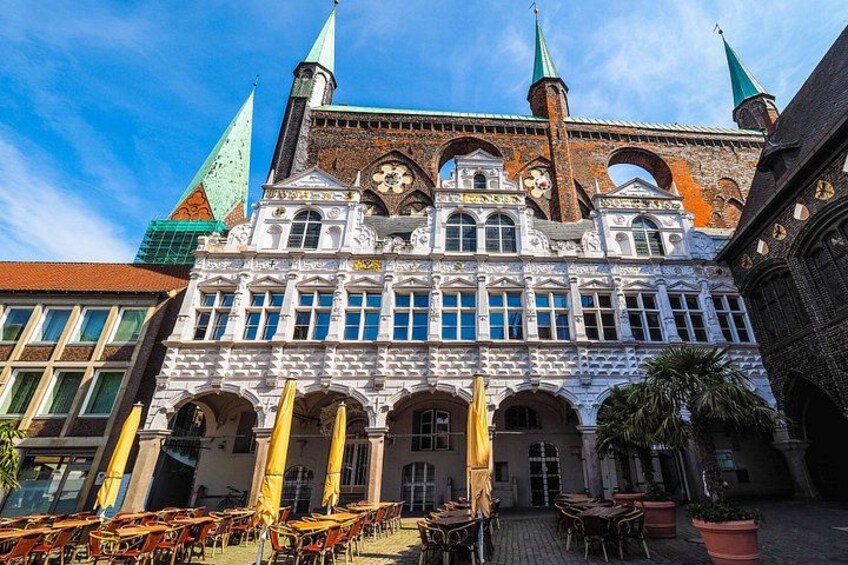 A historic building with arched windows and a clock tower. 4