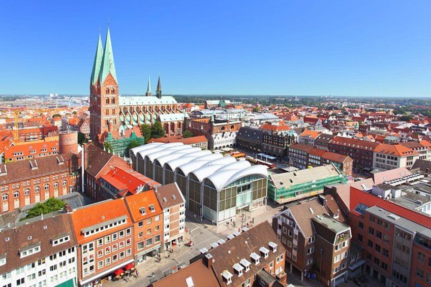 A cityscape with a prominent church, a modern building, and a dense urban area. 5
