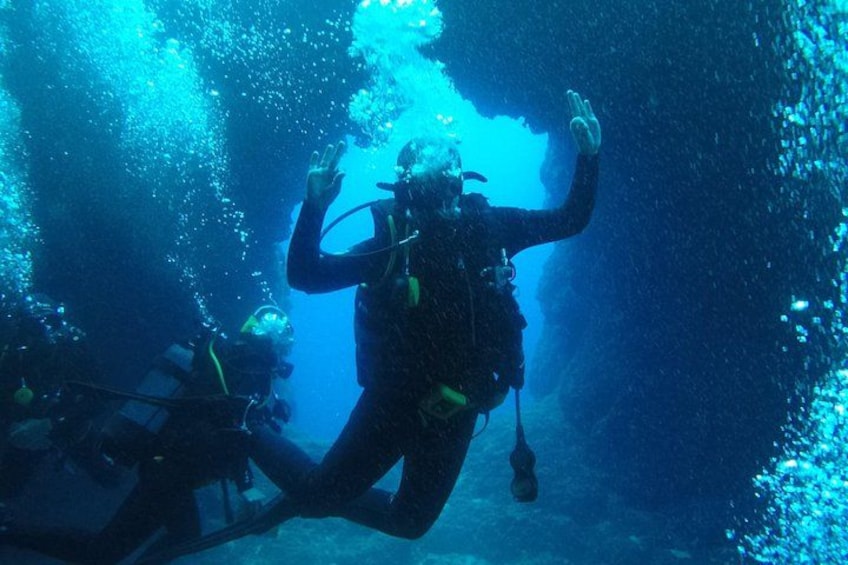 A diver underwater with bubbles and a diver's mask. 4