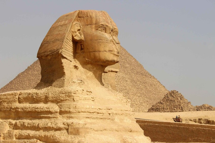 The Great Sphinx of Giza with the pyramids in the background. 3