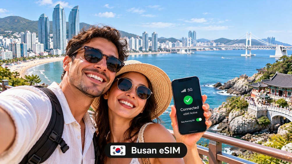 A couple taking a selfie with a smartphone displaying a 5G connection. 1