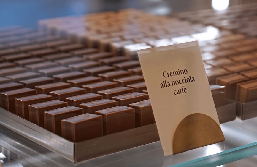 A display of chocolate bars with a sign indicating 'Cremino alla nocciola caffè'. 2