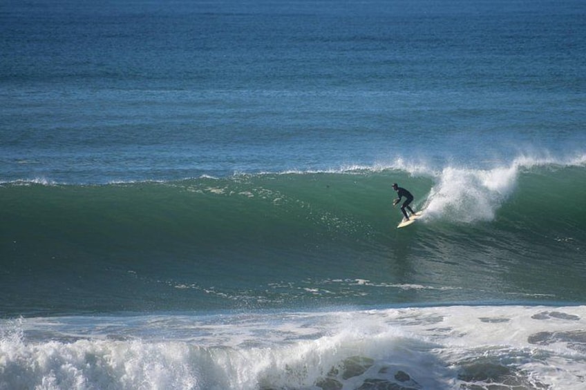 A surfer riding a wave in the ocean. 5