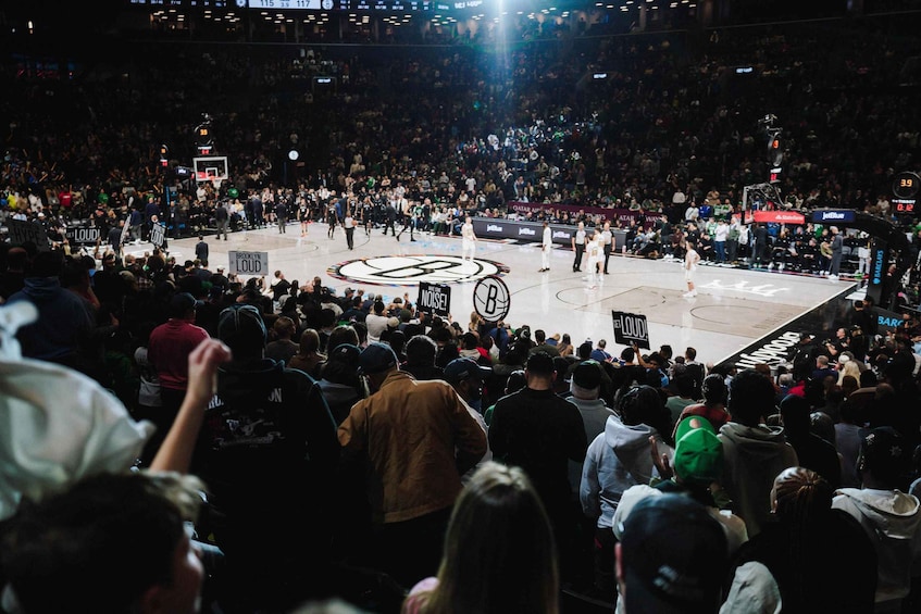 A basketball court with a crowd of spectators. 1