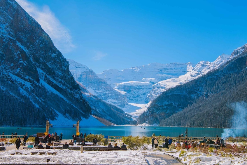 A snowy mountain landscape with a lake and a wooden dock. 4