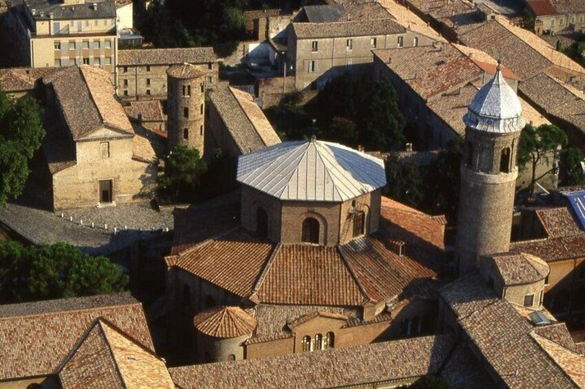 A historic town with a prominent church featuring a dome and a bell tower. 2