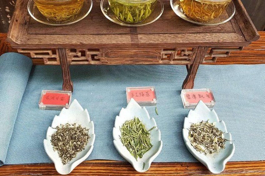 Three ceramic dishes with different herbs and labels on a wooden table. 2