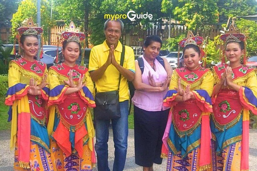 Un grupo de personas vestidas con trajes tradicionales, con un hombre con camisa amarilla y una mujer con blusa rosa. 3