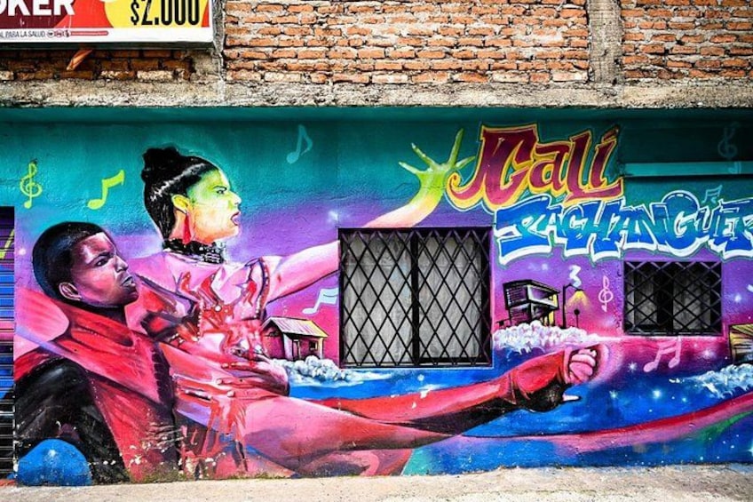 A colorful mural with a woman and a man, a building with barred windows, and a sign reading 'Call of the Jaguar'. 2