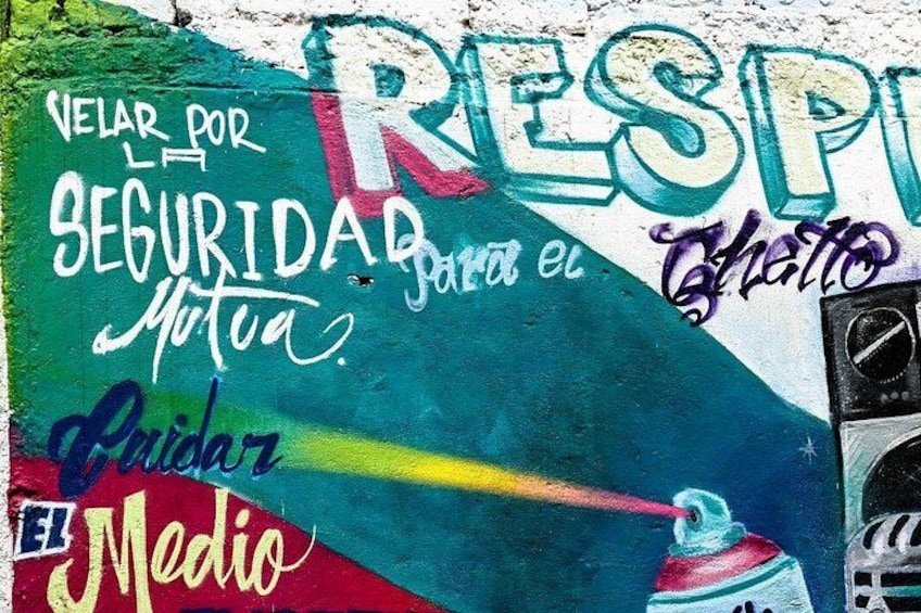 A colorful mural with graffiti and text, including 'Respir' and 'El Medio'. 3