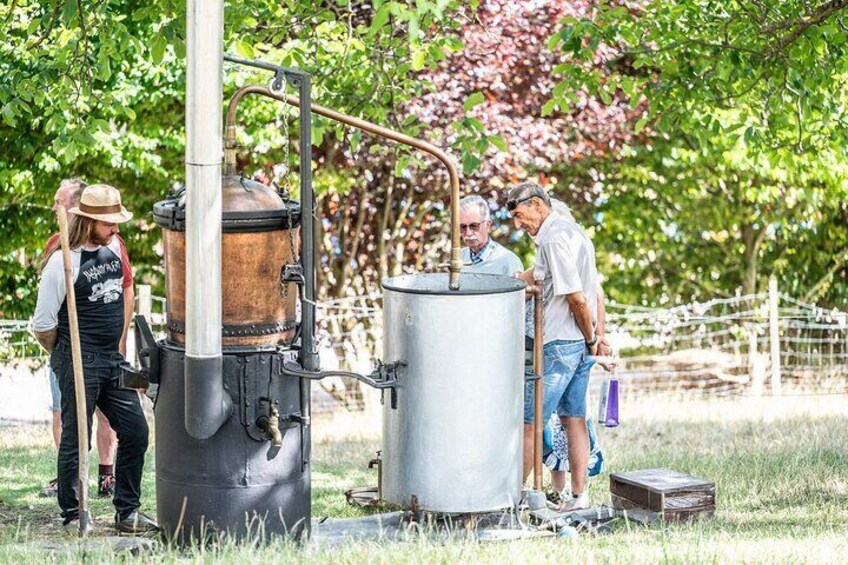 A group of people around industrial equipment in an outdoor setting. 4