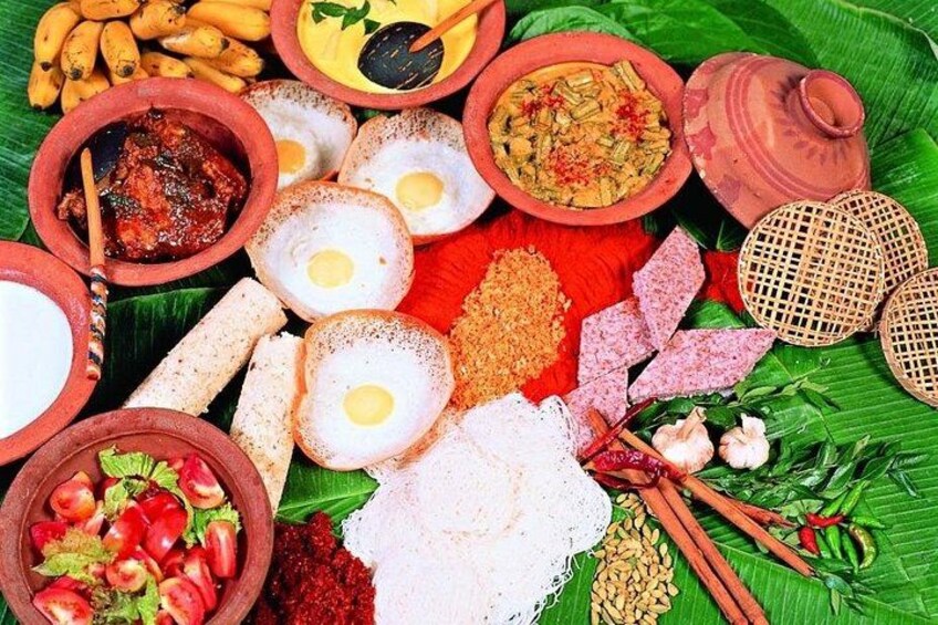 A variety of food items including eggs, bread, and spices arranged on a banana leaf. 2