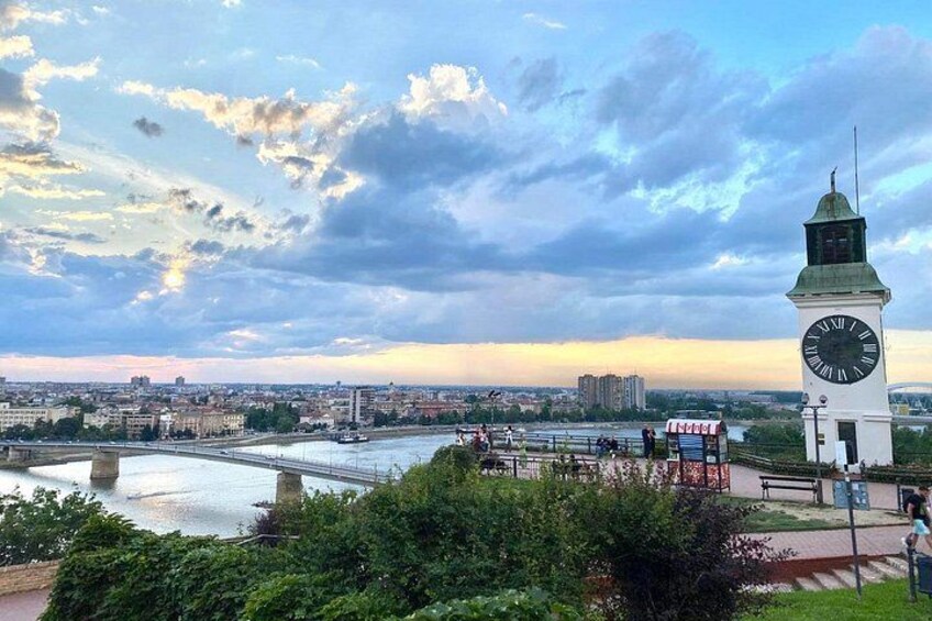 A clock tower, a river, and a cityscape with buildings and a bridge. 5