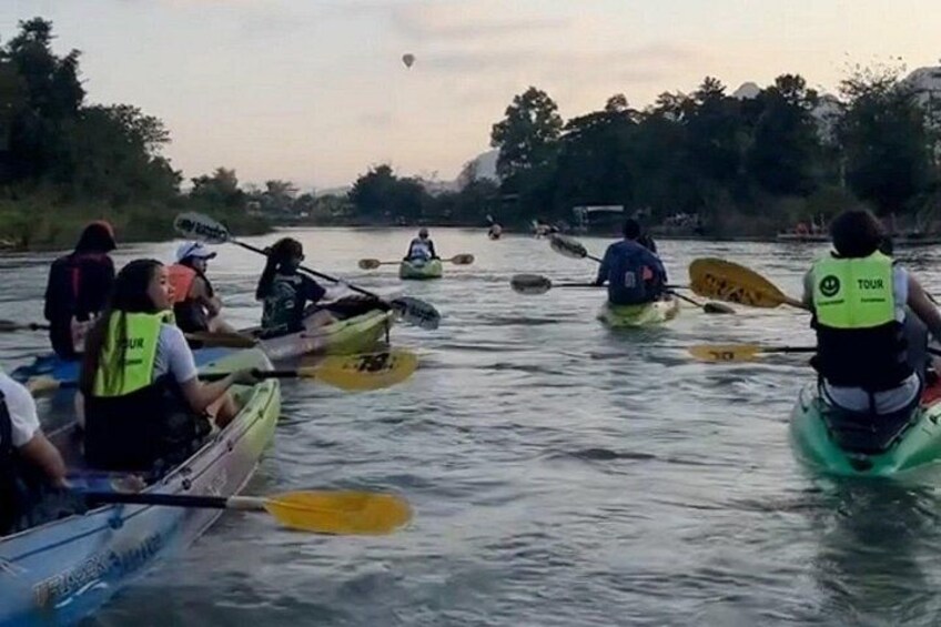 A group of people kayaking on a river. 3