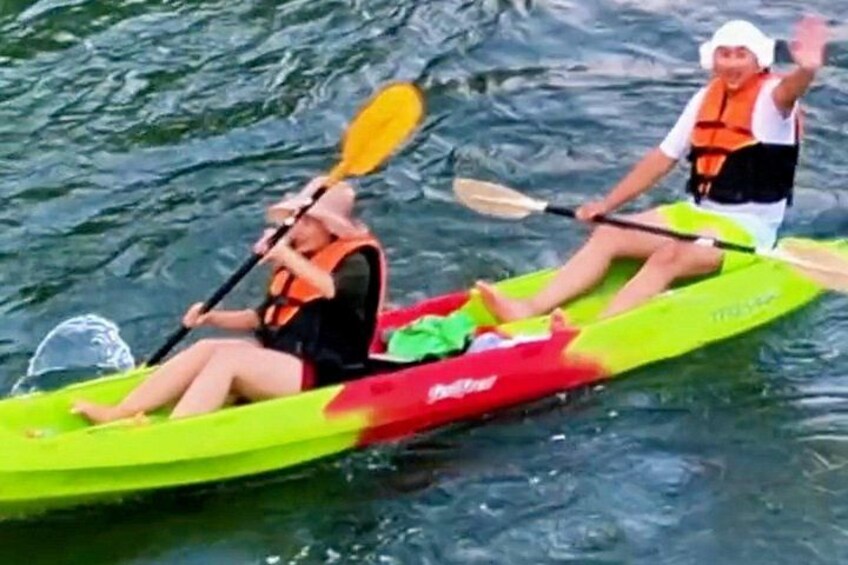 Two people kayaking on a body of water. 2