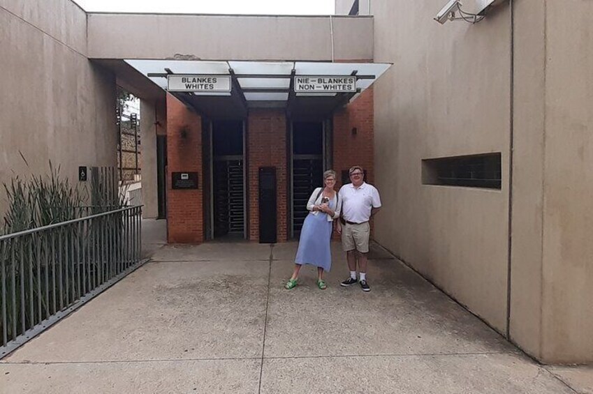 A building entrance with signs reading "BLANKES WHITES" and "BLANKES NON-WHITES". 4