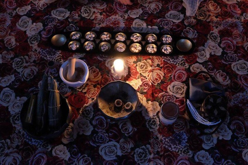 A table with various items including a candle, a bowl, a cup, and a decorative plate. 5