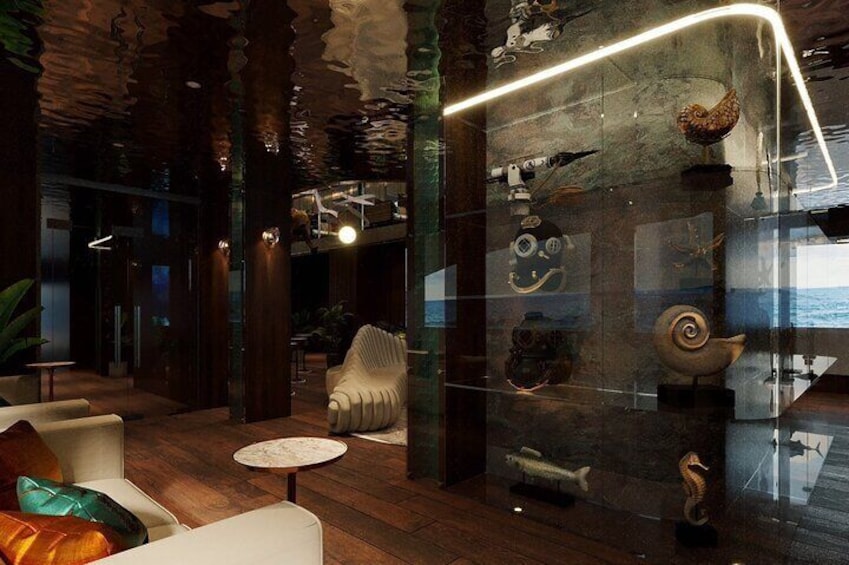 A modern interior with wooden floors, white furniture, and a glass display case with various objects. 5